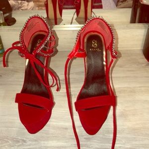 Glamorous red high heeled shoes with diamond back.